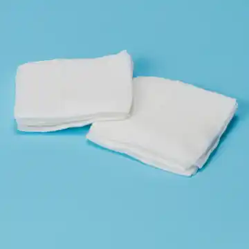 Two pieces of Compress Gauze on a blue background