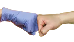 Thumbs up with blue dental gloves