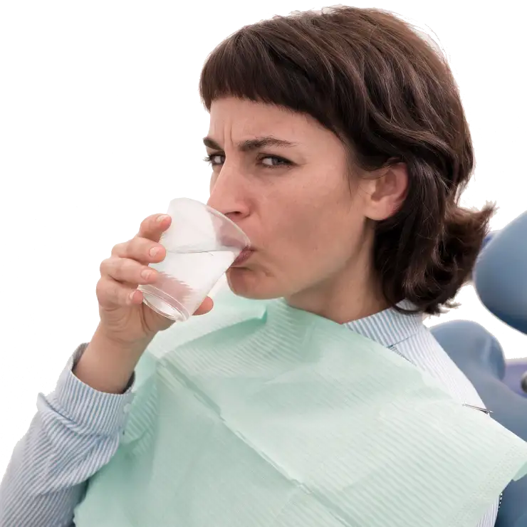 Woman patient sitting in a dental chair, rinsing her mouth with water and feeling like something is not right